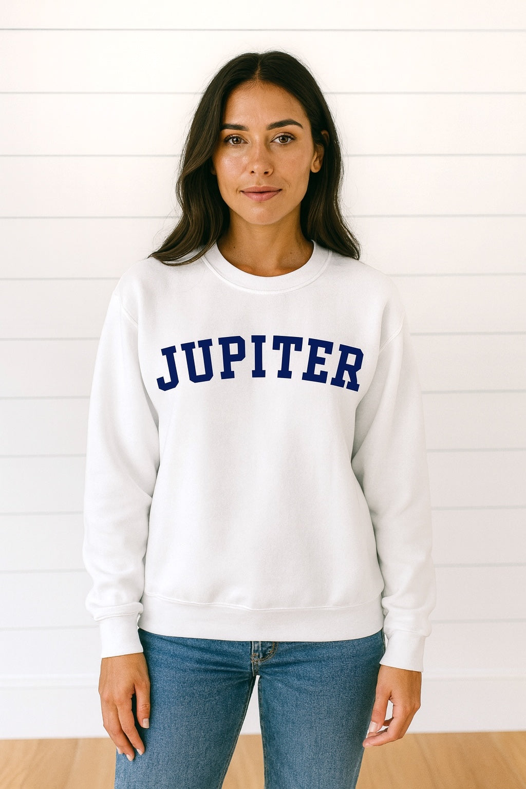 Person wearing a white sweatshirt with 'JUPITER' text against a white background